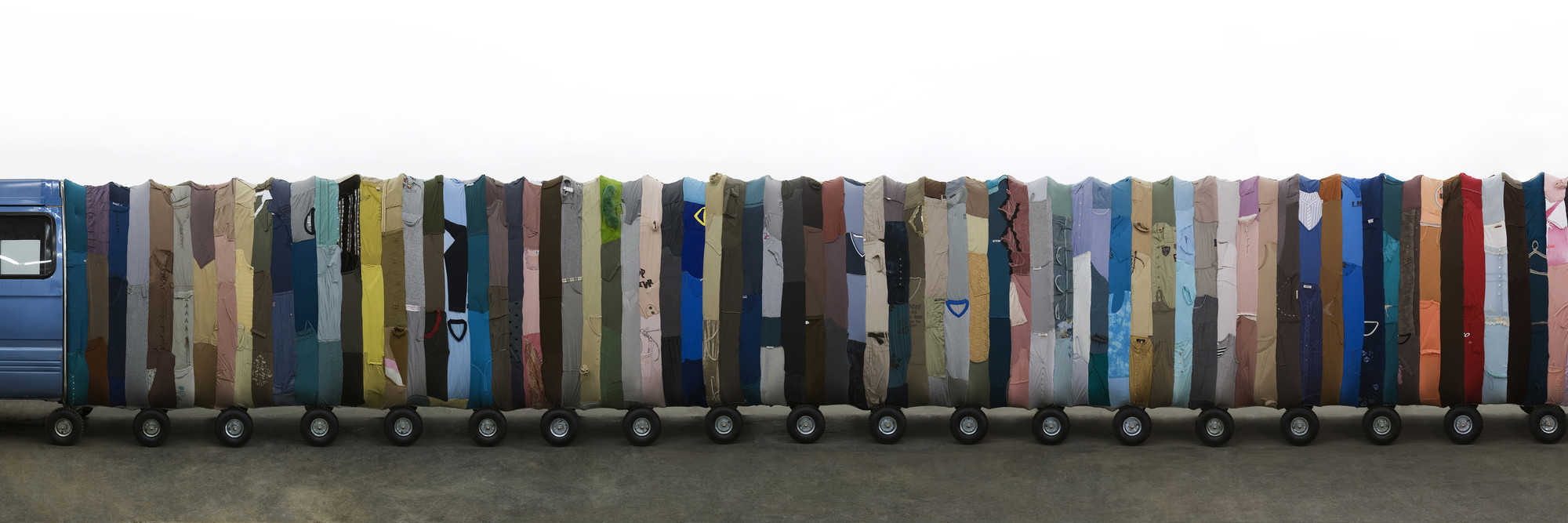 Yin Xiuzhen. Collective Subconscious. 2007. Minibus, stainless steel, used clothes, stools, music. Collection of the artist. © 2010 Yin Xiuzhen