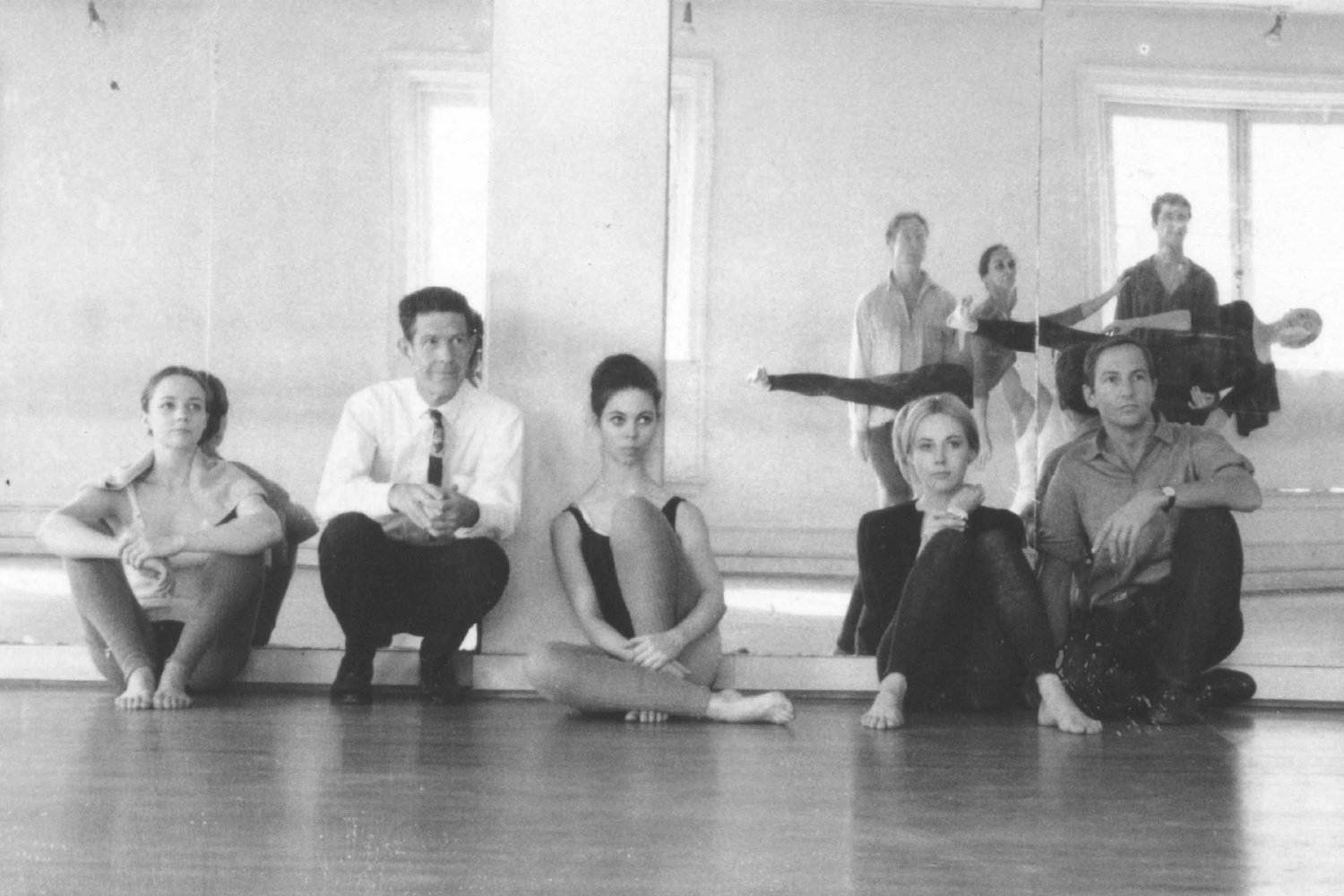 Rehearsal at Merce Cunningham's studio, 1964. Left to right, seated: Barbara Dilley Lloyd, John Cage, Sandra Neels, Shareen Blair, and Robert Rauschenberg. Left to right, standing: MC, Carolyn Brown, Steve Paxton, William David, and Viola Farber. Photo: Robert Rauschenberg © Robert Rauschenberg Foundation