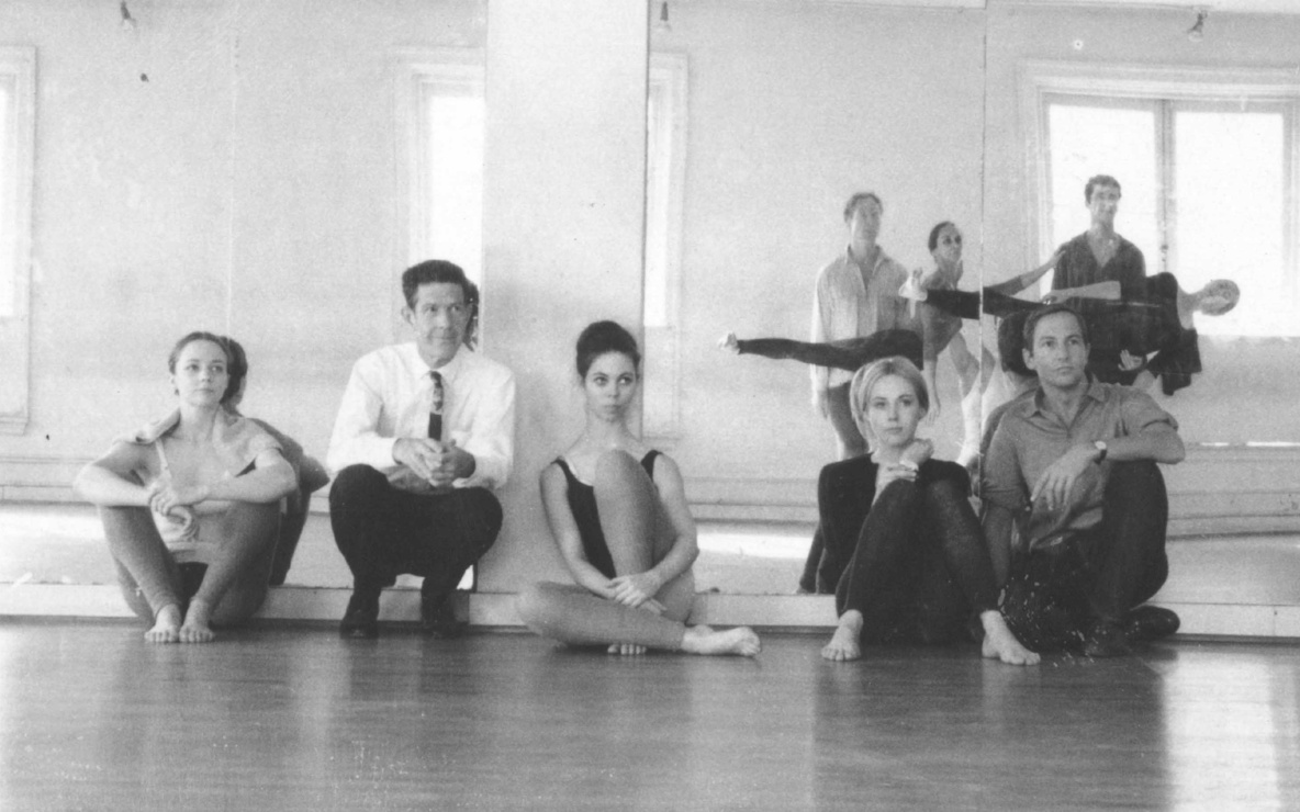 Rehearsal at Merce Cunningham's studio, 1964. Left to right, seated: Barbara Dilley Lloyd, John Cage, Sandra Neels, Shareen Blair, and Robert Rauschenberg. Left to right, standing: MC, Carolyn Brown, Steve Paxton, William David, and Viola Farber. Photo: Robert Rauschenberg &copy; Robert Rauschenberg Foundation