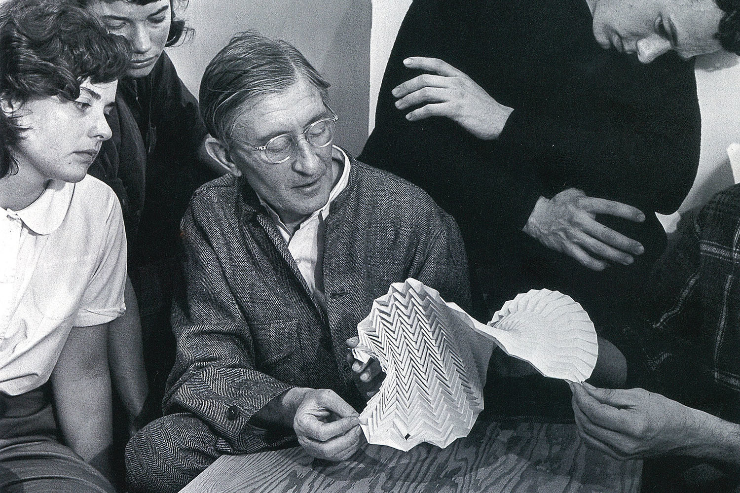 Josef Albers examining a folded paper construction with students at Black Mountain College, 1946. Photo: Genevieve Naylor