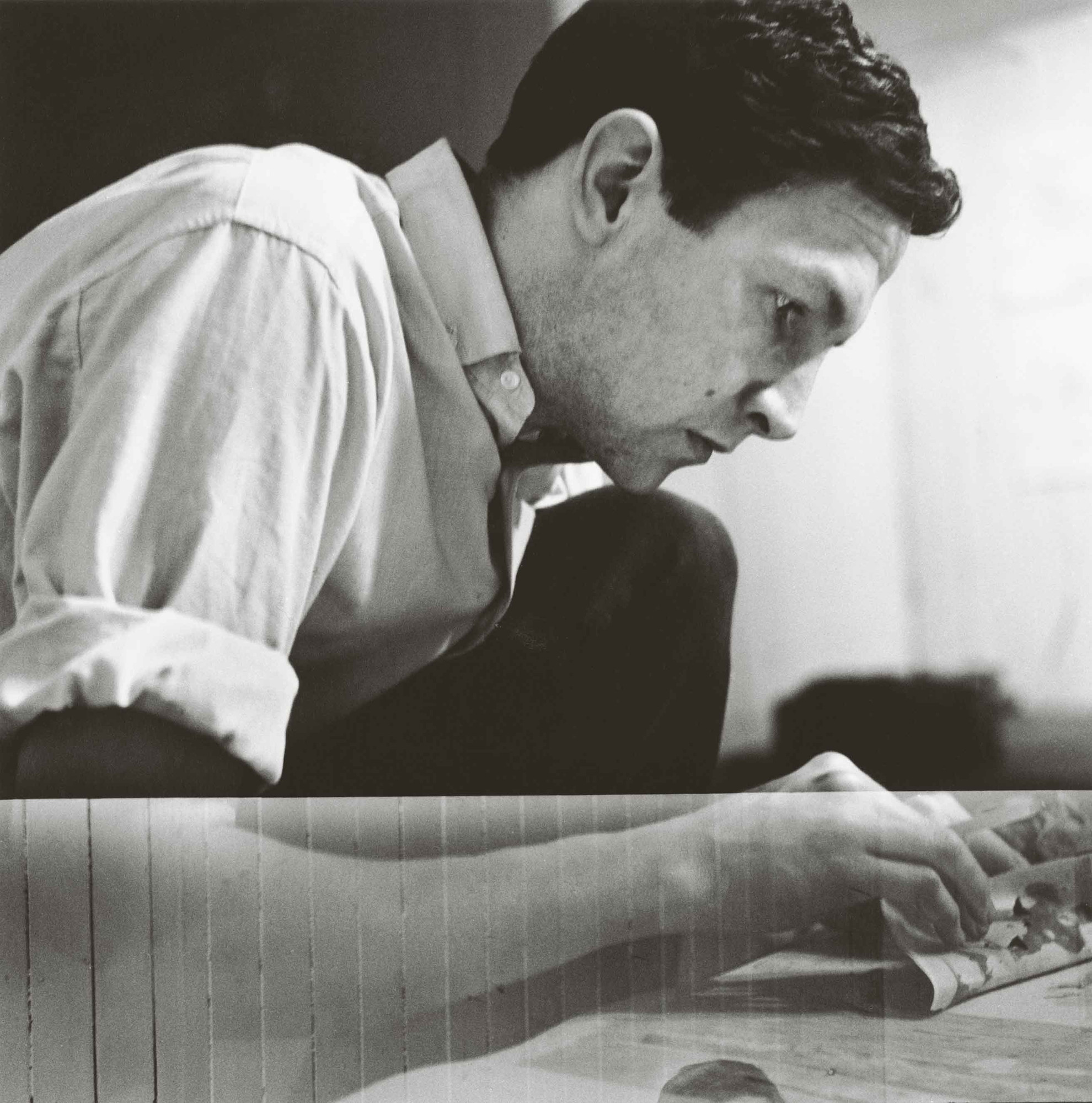 Rauschenberg working on a solvent transfer drawing in his Front Street studio, New York, 1958. Photograph: Jasper Johns. Photograph Collection. Robert Rauschenberg Foundation Archives, New York