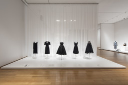 Gabrielle “Coco” Chanel (French, 1883–1971). House of Chanel (France, founded 1913). Evening dress. 1925–27. Silk chiffon, crepe-back satin, and glass bugle beads. Fashion Institute of Design & Merchandising, Los Angeles. Helen Larson Historic Fashion Collection. Purchase: FIDM Museum Fashion Council and other generous donors. Charles Creed (British, 1909–1966). Incorporated Society of London Fashion Designers (United Kingdom, founded 1942) Dress. 1942. Rayon crepe. Victoria and Albert Museum, London. Given by the President of the Board of Trade.Christian Dior (French, 1905–1957). House of Dior (France, founded 1947). Two-piece dress
(bodice and skirt). c. 1950. Silk taffeta. Indianapolis Museum of Art. Gift of Eleanore R. Carruth. Hubert de Givenchy (French, born 1927). Givenchy (France, founded 1952). Dress. 1968. Satin, jet beading, and equin trim. The Museum at the Fashion Institute of Technology. Gift of Jane Holzer. Arnold Scaasi (born Arnold Isaacs) (Canadian, 1931–2015). Dress. c. 1966. Tulle, black net shawl, and ribbon. Robert and Penny Fox Historic Costume Collection at Drexel University. Gift of the Schneidman family in memory of Margaret (Peggy) Wright Schneidman Tilghman. Image taken during installation of Items: Is Fashion Modern?