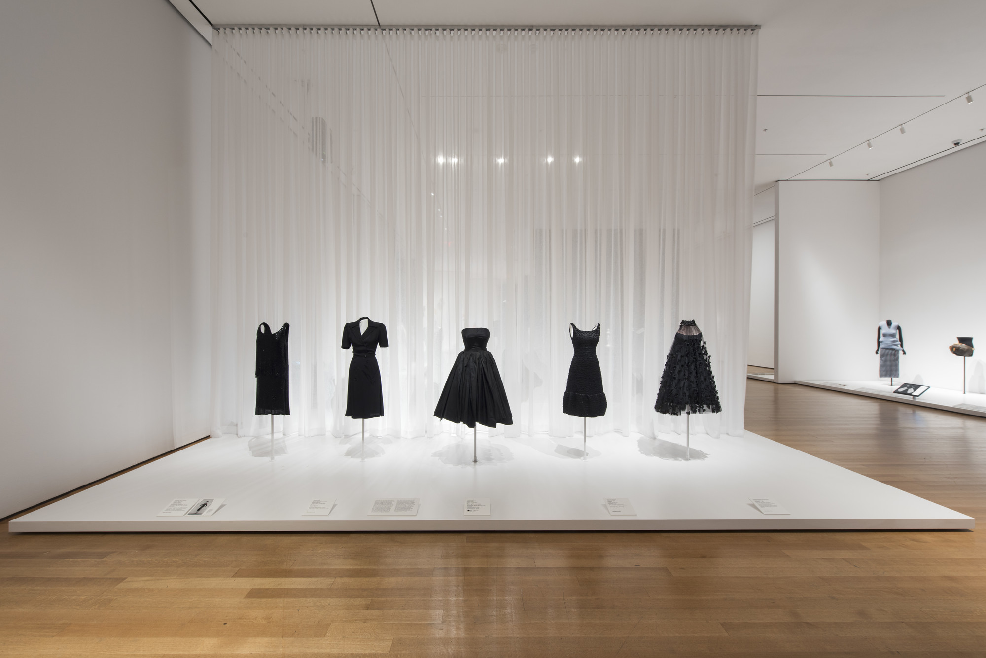 Gabrielle “Coco” Chanel (French, 1883–1971). House of Chanel (France, founded 1913). Evening dress. 1925–27. Silk chiffon, crepe-back satin, and glass bugle beads. Fashion Institute of Design & Merchandising, Los Angeles. Helen Larson Historic Fashion Collection. Purchase: FIDM Museum Fashion Council and other generous donors. Charles Creed (British, 1909–1966). Incorporated Society of London Fashion Designers (United Kingdom, founded 1942) Dress. 1942. Rayon crepe. Victoria and Albert Museum, London. Given by the President of the Board of Trade.Christian Dior (French, 1905–1957). House of Dior (France, founded 1947). Two-piece dress
(bodice and skirt). c. 1950. Silk taffeta. Indianapolis Museum of Art. Gift of Eleanore R. Carruth. Hubert de Givenchy (French, born 1927). Givenchy (France, founded 1952). Dress. 1968. Satin, jet beading, and equin trim. The Museum at the Fashion Institute of Technology. Gift of Jane Holzer. Arnold Scaasi (born Arnold Isaacs) (Canadian, 1931–2015). Dress. c. 1966. Tulle, black net shawl, and ribbon. Robert and Penny Fox Historic Costume Collection at Drexel University. Gift of the Schneidman family in memory of Margaret (Peggy) Wright Schneidman Tilghman. Image taken during installation of _Items: Is Fashion Modern?_ 
