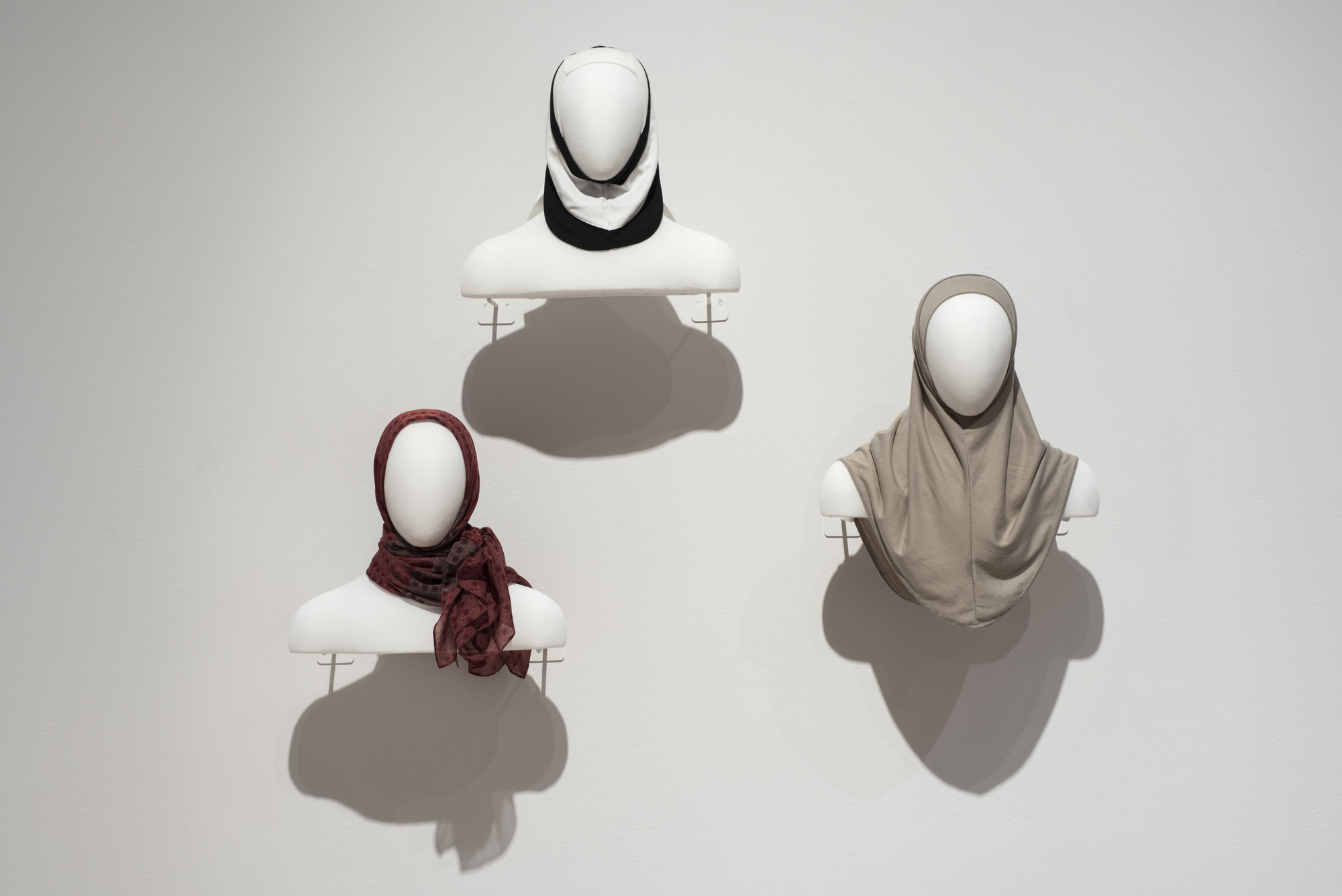 Unknown designer. Hijab. 2017. Cotton and Lycra. Manufactured by Zaffron Shop (United States, founded 2010). Purchased for the exhibition. Hana Tajima (British, born 1986). Uniqlo (Japan, founded 1984). Hijab. 2017. Rayon, polyester, spandex, cotton, and cupro. Donated by the manufacturer. Cindy van den Bremen (Dutch, born 1972). Capsters (The Netherlands, founded 2001). Sports headgear. 1999. Fleece. Manufactured by Capsters. The Museum of Modern Art, New York. Gift of Cindy van den Bremen, 2006. Image taken during installation of _Items: Is Fashion Modern?_