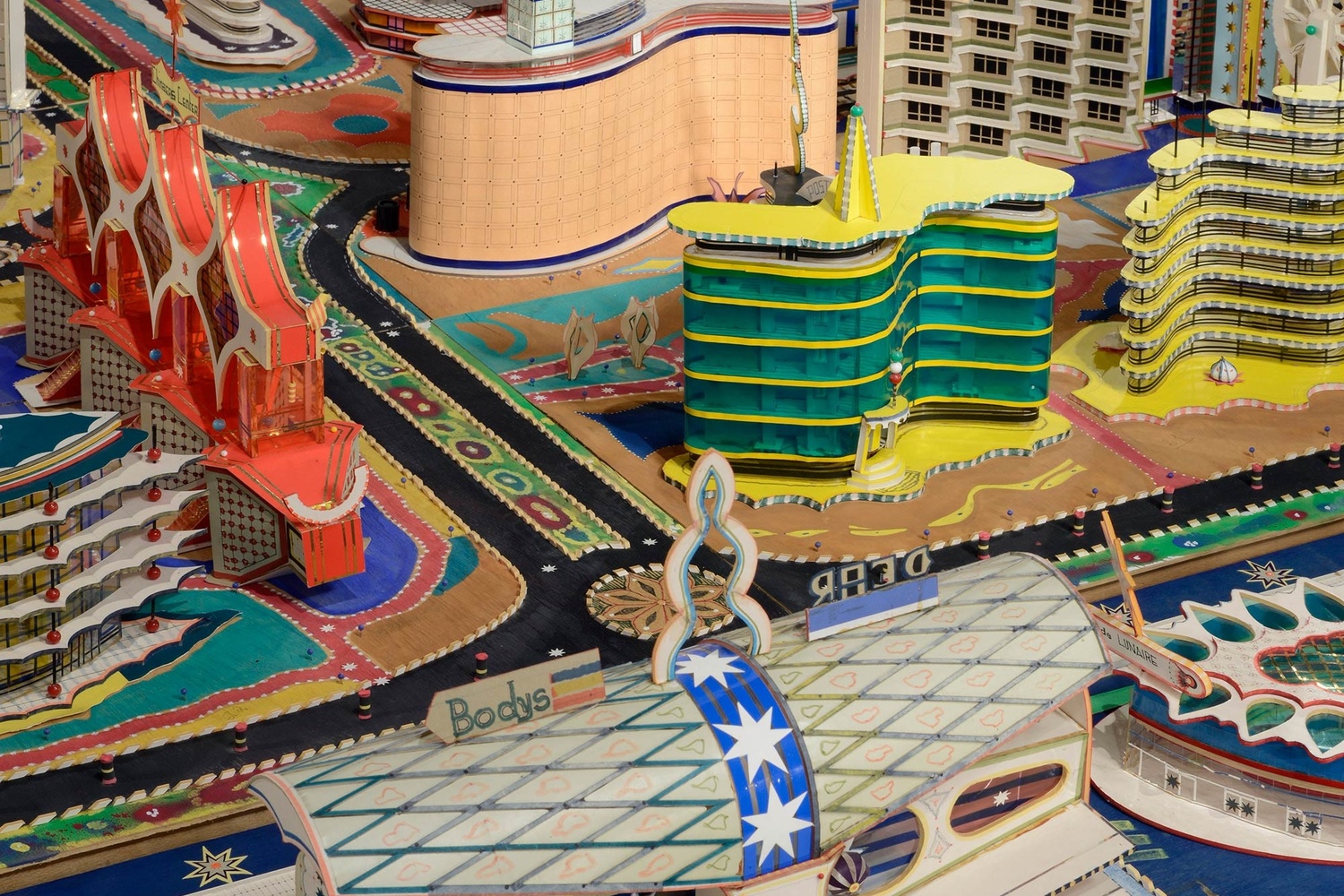 Bodys Isek Kingelez. Ville Fantôme (detail). 1996. Paper, paperboard, plastic, and other materials, 47 1/4 × 224 7/16 × 94 1/2″ (120 × 570 × 240 cm). CAAC – The Pigozzi Collection, Geneva. © Bodys Isek Kingelez. Photo: Maurice Aeschimann. Courtesy CAAC – The Pigozzi Collection