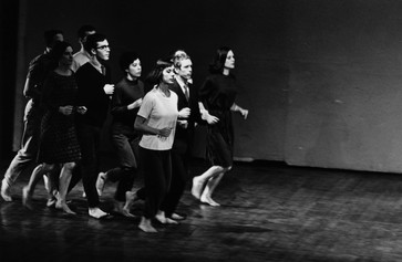 Peter Moore’s photograph of Robert Rauschenberg, Joseph Schlichter (back), Sally Gross, Tony Holder, Deborah Hay, and Robert Morris (middle), Yvonne Rainer, Alex Hay, and Lucinda Childs (front) in We Shall Run, 1963. Performed in Two Evenings of Dances by Yvonne Rainer, Wadsworth Atheneum, Hartford, Connecticut, March 7, 1965. © Barbara Moore/Licensed by VAGA at ARS, NY. Courtesy Paula Cooper Gallery, New York