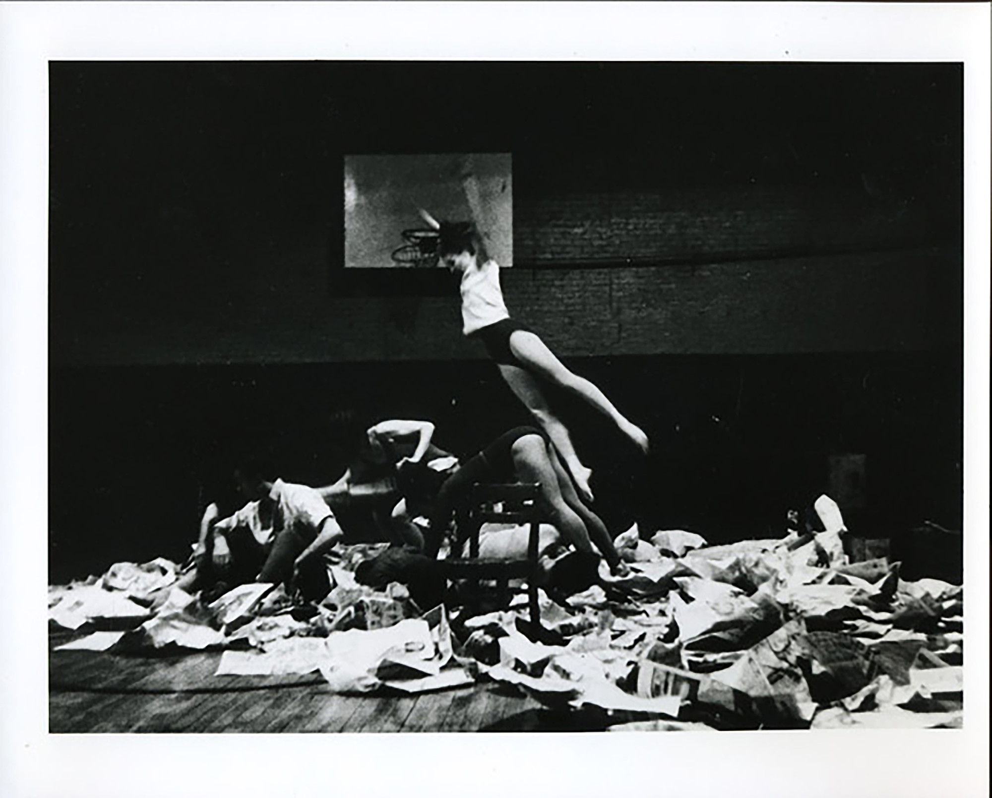 Al Giese’s photograph of Ruth Emerson in Carolee Schneemann’s _Newspaper Event_. Performed at _Concert of Dance #3_, Judson Memorial Church, January 29, 1963. © Estate of Al Giese/Licensed by VAGA, New York, NY. Courtesy of Carolee Schneemann, Galerie Lelong & Co., and P•P•O•W, New York