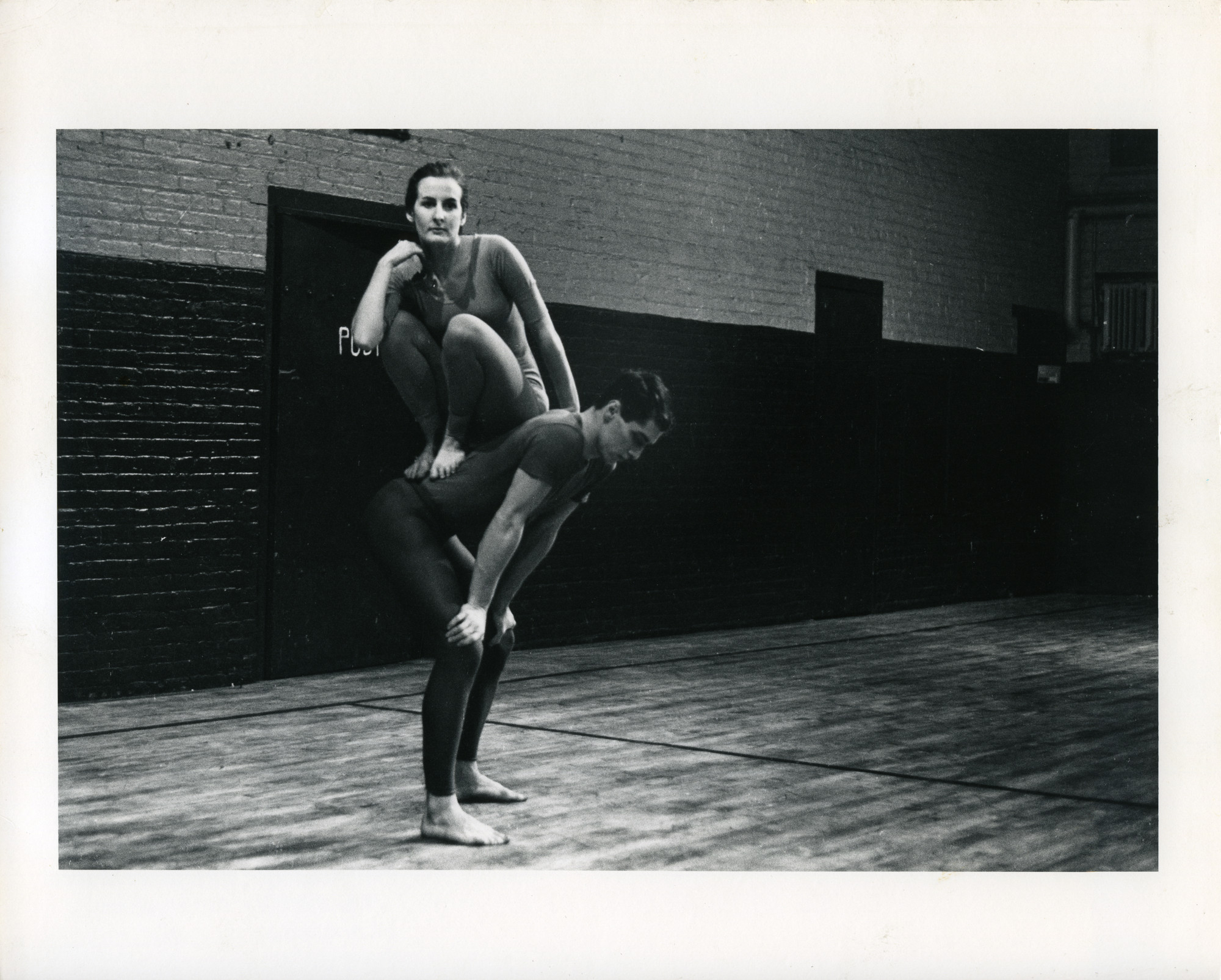 Peter Moore’s photograph of Trisha Brown and Steve Paxton in Brown’s _Lightfall_. Performed at _Concert of Dance #4_, Judson Memorial Church, January 30, 1963. © Barbara Moore/Licensed by VAGA, New York, NY. Courtesy Paula Cooper Gallery, New York