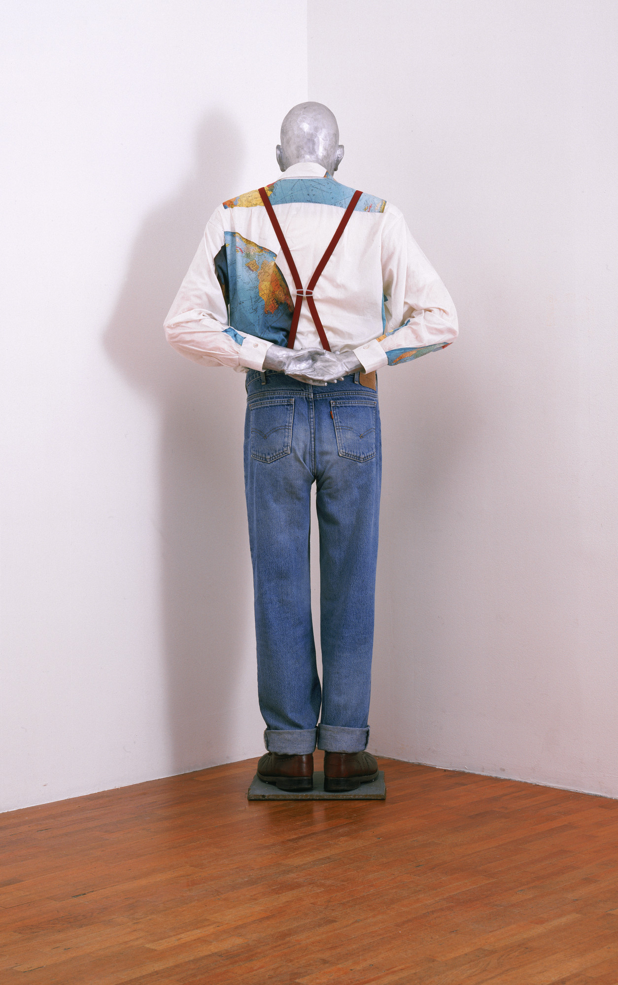 Martin Kippenberger. _Martin, Into the Corner, You Should Be Ashamed of Yourself (Martin, ab in die Ecke und schäm dich)_. 1992. Cast aluminum, clothing, and iron plate. 71 1/2 x 29 1/2 x 13 1/2" (181.6 x 74.9 x 34.3 cm). Blanchette Hooker Rockefeller Fund Bequest, Anna Marie and Robert F. Shapiro, Jerry I. Speyer, and Michael and Judy Ovitz Funds. The Museum of Modern Art. © Gisela Capitain