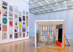 Installation view of Martin Kippenberger's _Spiderman Studio (Spiderman-Atelier),_1996, at The Museum of Modern Art.
Wood, metal, plastic, Plexiglas, mirrors, bronze, Styrofoam, painted canvases, vodka bottle, and balsa, 110 1/4 x 120 1/16 x 154 3/4 in.
The Herbert Foundation 

 © Estate Martin Kippenberger, Galerie Gisela Capitain, Cologne 

 Photo © 2009 Jason Mandella