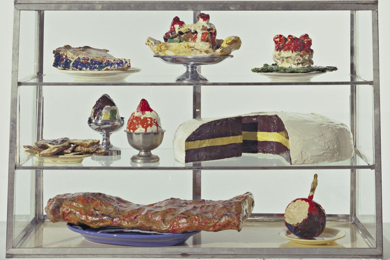 Pastry Case, I Date: 1961-62 Medium: Burlap and muslin soaked in plaster, painted with enamel, metal bowls, and ceramic plates in glass-and-metal case Dimensions: 20 3/4 x 30 1/8 x 14 3/4" (52.7 x 76.5 x 37.3 cm) Credit Line: The Sidney and Harriet Janis Collection MoMA Number: 639.1967.a-dd