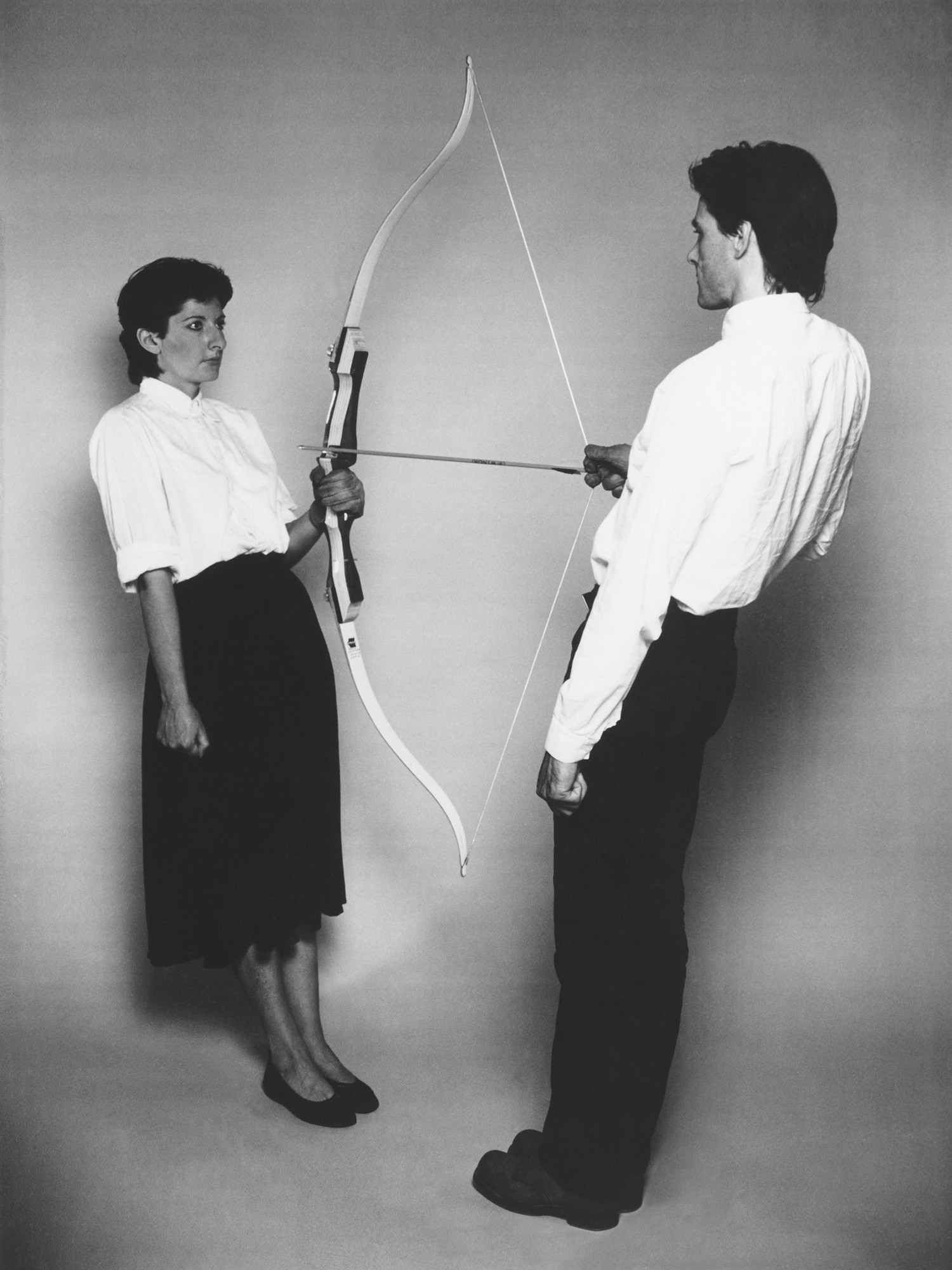 Marina Abramović and Ulay. _Rest Energy_. Performed in August 1980 for four minutes at ROSC’80, National Gallery of Ireland. Production image (black and white) for 16mm film transferred to video (color, sound). 47 min. © 2010 Marina Abramović. Courtesy Marina Abramović and Sean Kelly Gallery/Artists Rights Society (ARS), New York