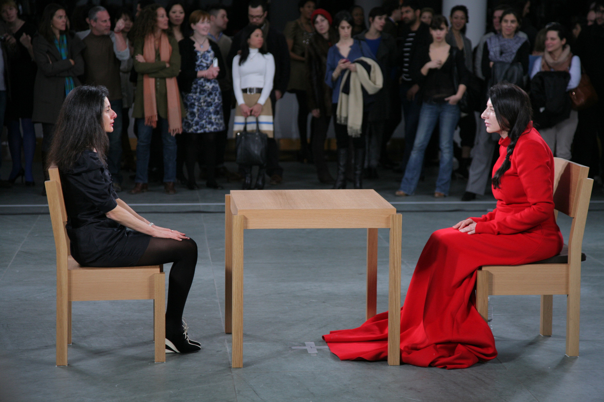 Installation view of Marina Abramović’s performance _The Artist Is Present_ at The Museum of Modern Art, 2010. Photo by Scott Rudd. For her longest solo piece to date, Abramović will sit in silence at a table in the Museum’s Donald B. and Catherine C. Marron Atrium during public hours, passively inviting visitors to take the seat across from her for as long as they choose within the timeframe of the Museum’s hours of operation. Although she will not respond, participation by Museum visitors completes the piece and allows them to have a personal experience with the artist and the artwork. © 2010 Marina Abramović. Courtesy the artist and Sean Kelly Gallery/Artists Rights Society (ARS), New York