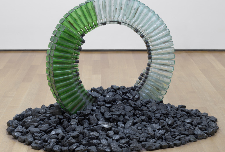 David Hammons. Untitled (Night Train). 1989. Glass bottles, caps, silicone glue, and coal, dimensions variable, approximately 30 x 42 x 42" (76.2 x 106.7 x 106.7 cm). Gift of the Hudgins Family in memory of Lawrence D. “Butch” Morris