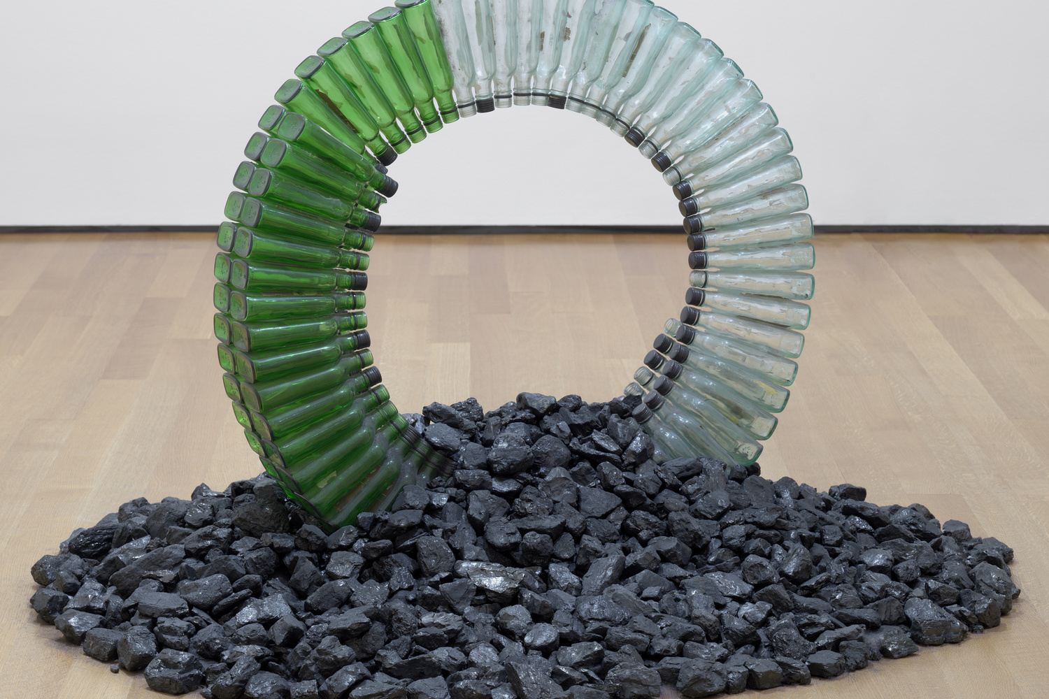 David Hammons. Untitled (Night Train). 1989. Glass bottles, caps, silicone glue, and coal, dimensions variable, approximately 30 x 42 x 42" (76.2 x 106.7 x 106.7 cm). Gift of the Hudgins Family in memory of Lawrence D. “Butch” Morris