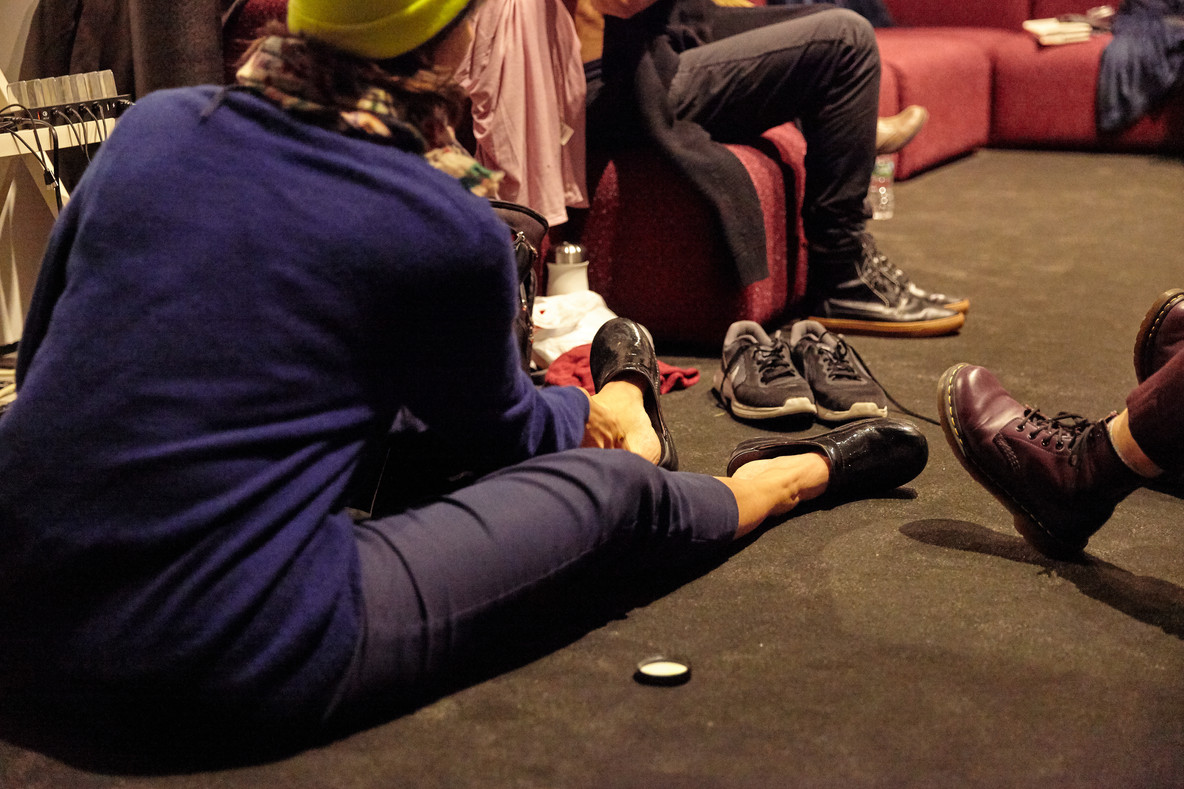 After performances at 11:30 a.m. and 1:30 p.m., they stretch and put on shoes to prepare for the next show.