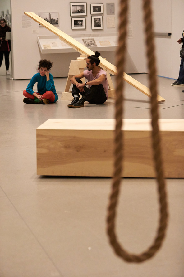 Sound escapes through the small crack at one side of the plywood box. Lee Relvas and Miguel Ángel Guzmán sit on the floor, listening quietly for the duration of the piece.