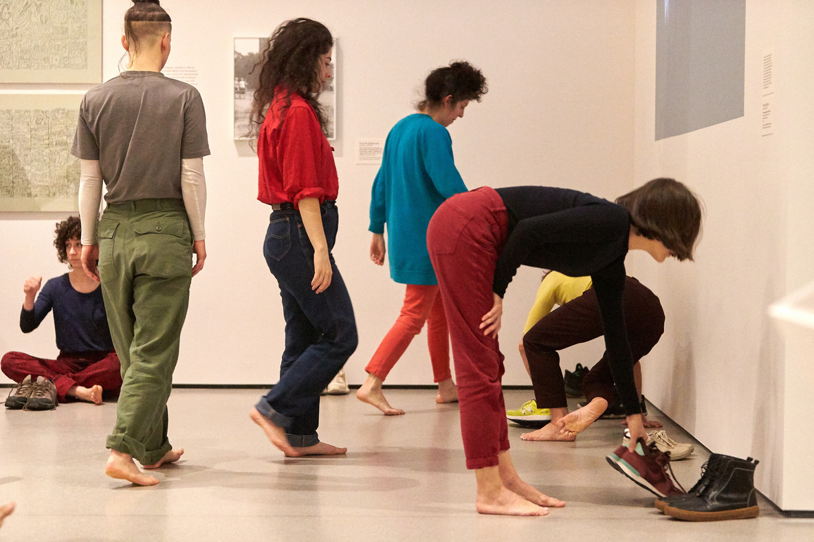 While Huddle is intended to be performed in bare feet, the other Dance Constructions are performed in tennis shoes. Here, the performers put on their shoes and prepare for the remainder of the works.