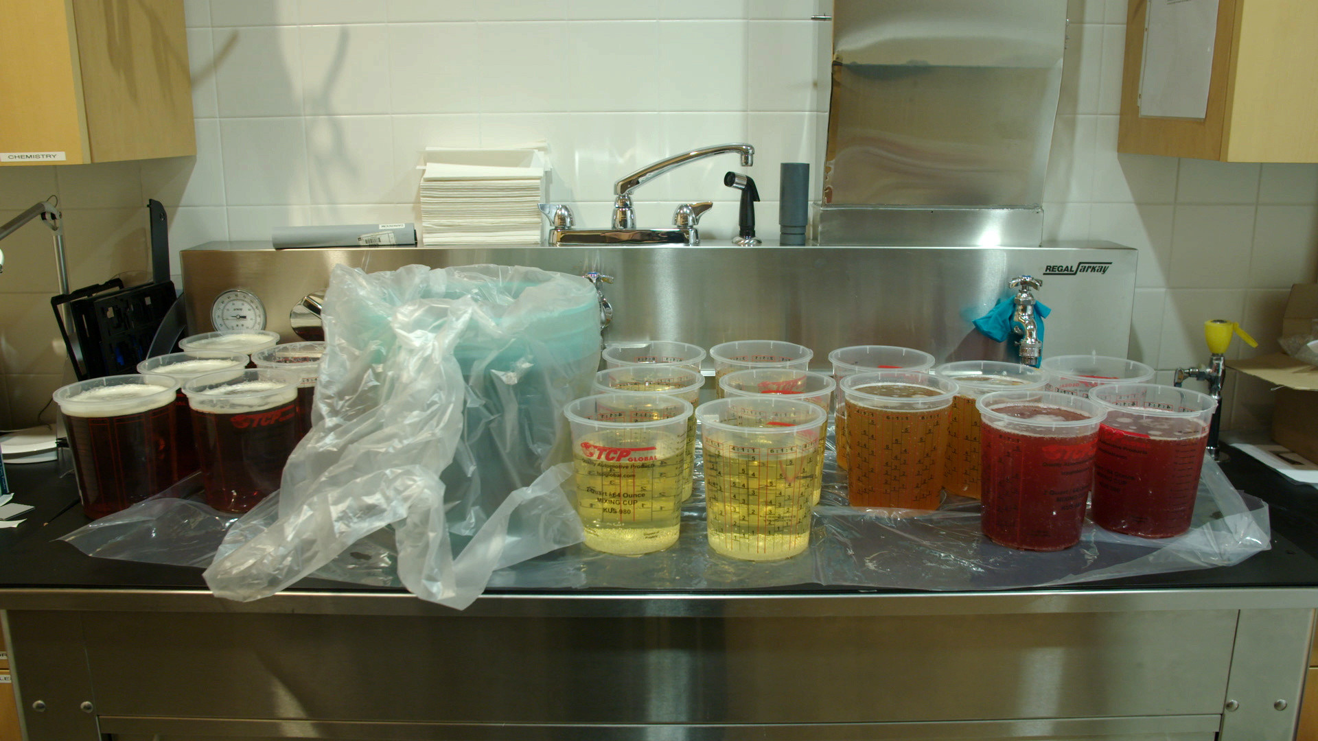 The containers in this image hold all of the carbonated liquid ingredients—including microbrewed beer and kombucha for “Williamsburg” and champagne for “Bottle Service”—for blending into the drinks.
