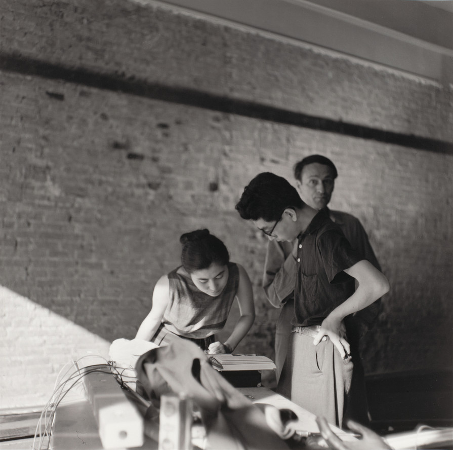 Yoko Ono, Toshi Ichiyanagi, and Jonas Mekas in gallery during Paintings &amp; Drawings by Yoko Ono, AG Gallery, New York, July 17–30, 1961. Photo: George Maciunas