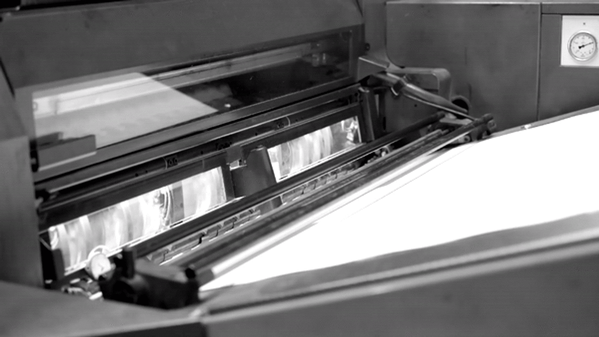 Printing paper being fed into the machine and wrapping around the printing cylinders. Video by Marc Sapir