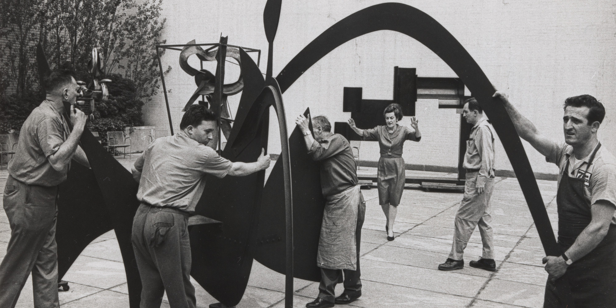 Dorothy C. Miller in the The Abby Aldrich Rockefeller Sculpture Garden installing Alexander Calder’s Black Widow (1959). c. 1963–69. Photo: Dan Budnik. © Dan Budnik. Photographic Archive. The Museum of Modern Art Archives, New York
