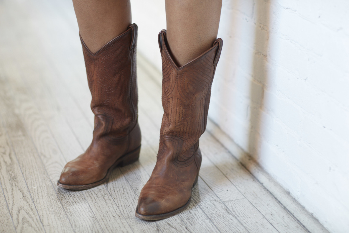 Allison Janae Hamilton in her cowboy boots during exhibition installation