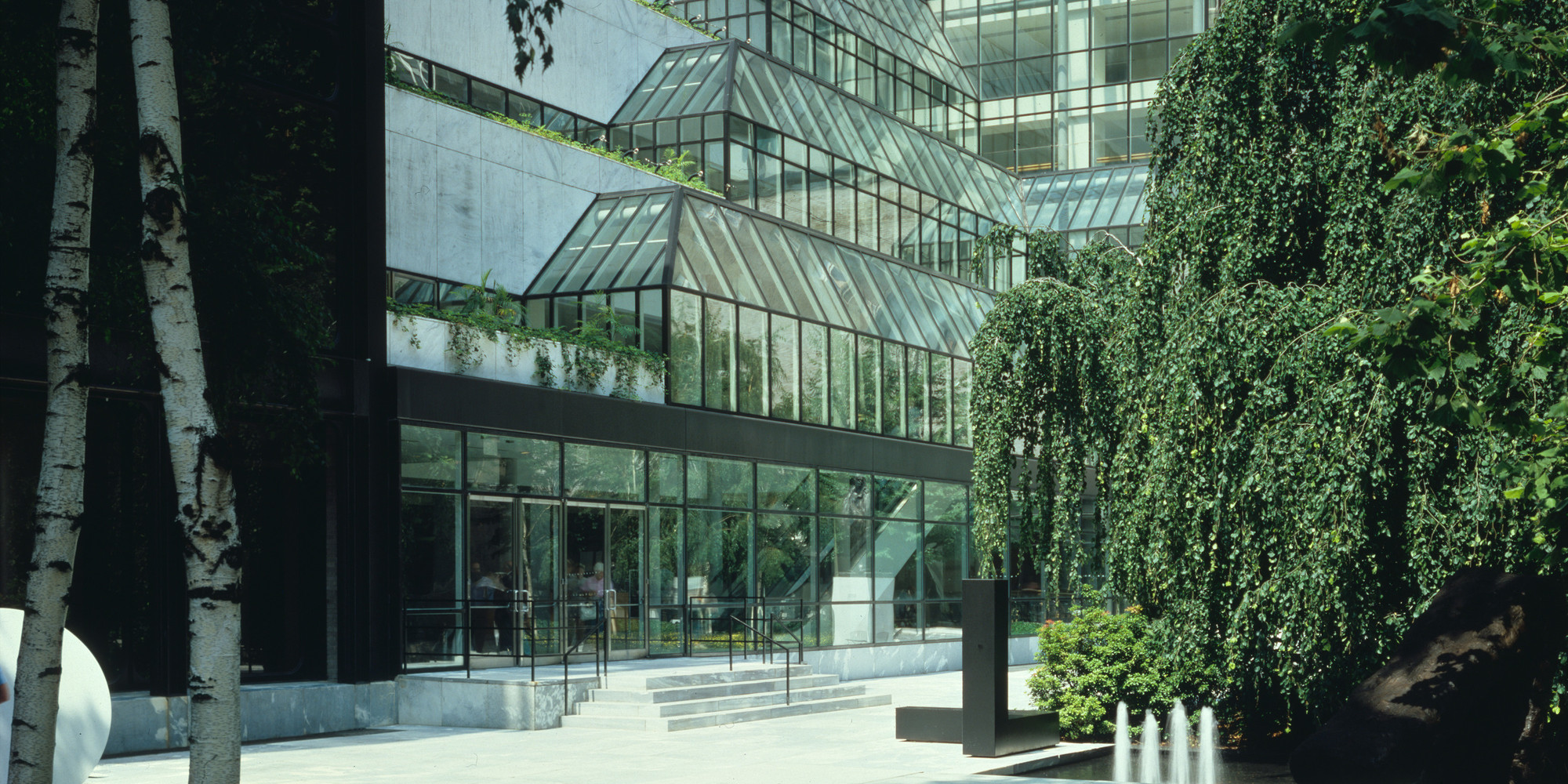 Foreground: The Abby Aldrich Rockefeller Sculpture Garden, designed in 1953 by Philip Johnson; Background: Garden Hall, designed in 1984, and Museum Tower, designed in 1982, by César Pelli & Associates. Color transparency, 4 × 5" (10.1 × 12.7 cm). Photographic Archive. The Museum of Modern Art Archives, New York. © The Museum of Modern Art, New York. Photo: Scott Frances