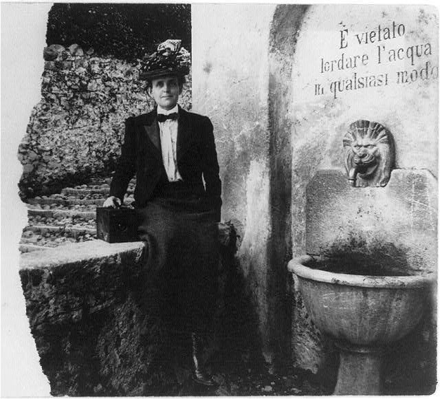 Frances Benjamin Johnston sitting with her camera, c. 1900