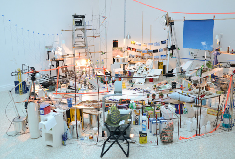 Sarah Sze. Triple Point (Pendulum). 2013. Salt, water, stone, string, projector, video, pendulum, and other materials, dimensions variable, approximately 150 × 210 × 200&#34; (381 × 533.4 × 508 cm). Gift of the International Council of The Museum of Modern Art, Agnes Gund, Ronald S. and Jo Carole Lauder, and Sharon Percy Rockefeller, in honor of the 60th Anniversary of the International Council