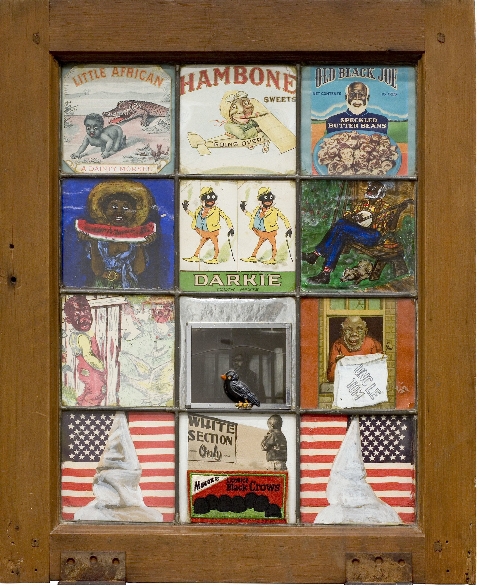 Betye Saar. _Black Crows in the White Section Only_. 1972. Assemblage with glass negative, found printed paper, found metal object, gouache on paper and fabric in wood and glass window frame, 22 × 18 × 1 3/4" (55.9 × 45.7 × 4.4 cm). Collection halley k harrisburg and Michael Rosenfeld, New York. © 2019 Betye Saar, courtesy of the artist and Roberts Projects, Los Angeles. Image courtesy of Michael Rosenfeld Gallery LLC, New York, NY.