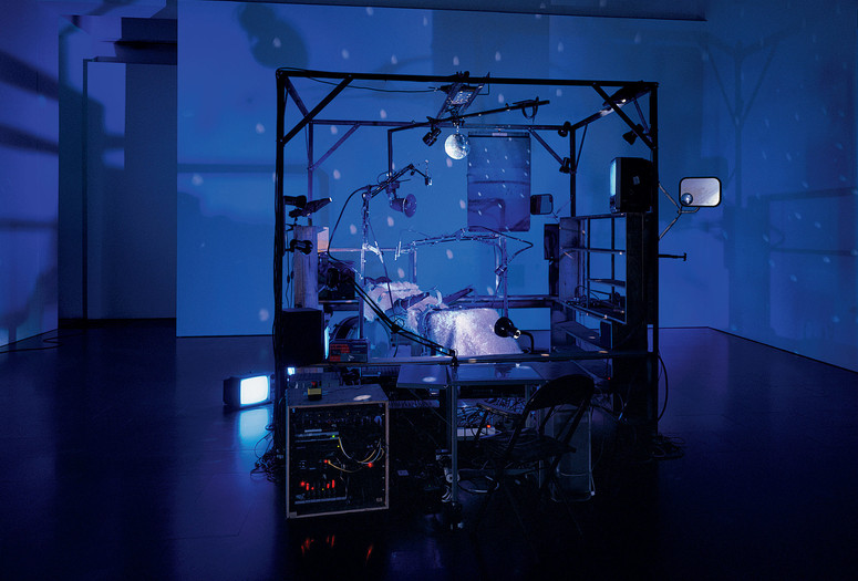 Janet Cardiff and George Bures Miller. The Killing Machine. 2007. Pneumatics, robotics, electromagnetic beaters, dentist chair, electric guitar, CRT monitors, computer, various control systems, lights, and sound (approx. 5 min.). 9′ 10″ x 13′ 1″ x 8′ 2″ (118 x 157 x 98 cm). The Museum of Modern Art, New York. Gift of the Julia Stoschek Foundation, Düsseldorf, and the Dunn Bequest. © 2019 Janet Cardiff and George Bures Miller. Photo: Seber Ugarte &amp; Lorena López. Courtesy the artists and Luhring Augustine, New York.