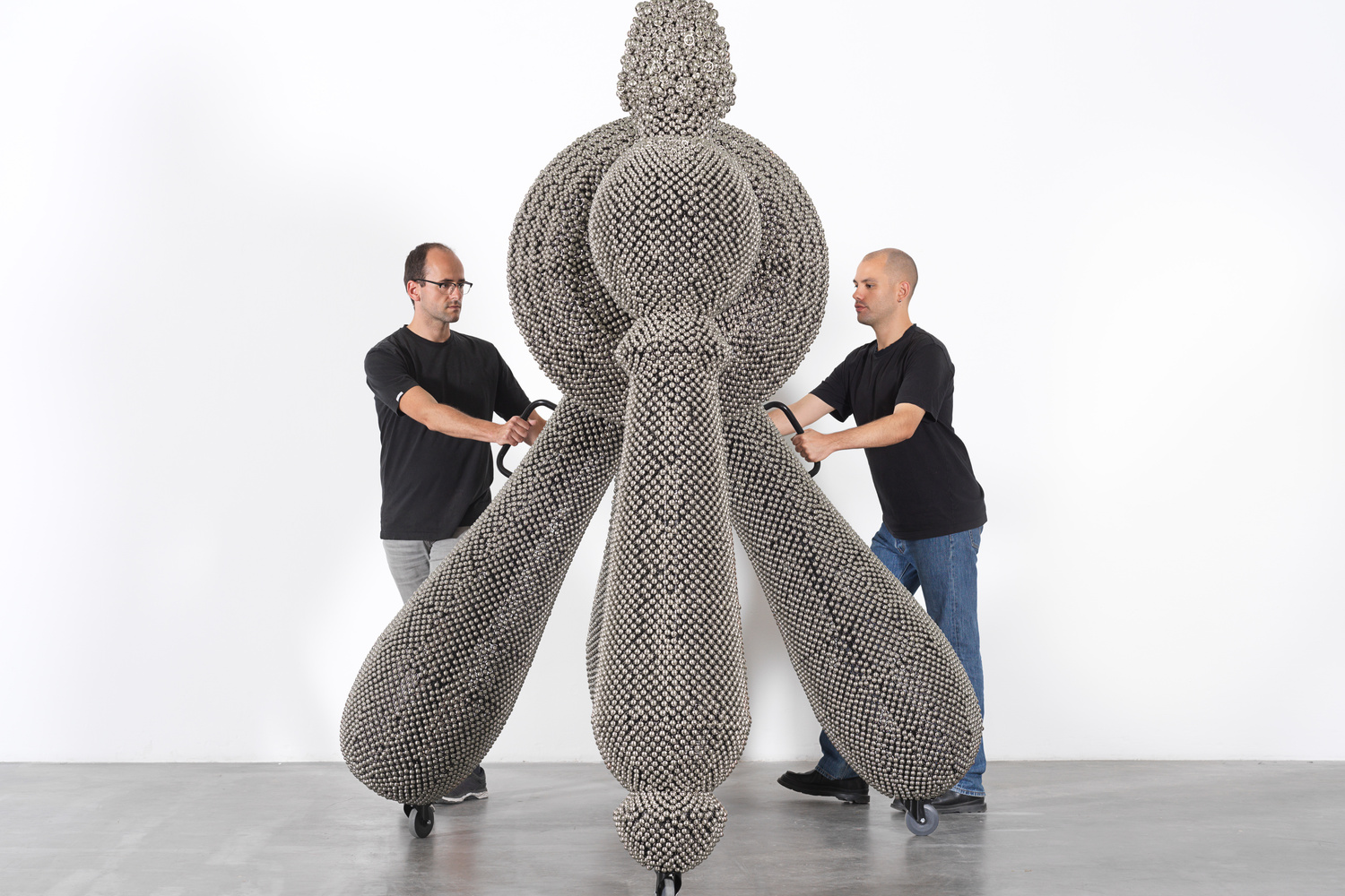 Haegue Yang. Sonic Handles – Law of Three Bodies from the installation Handles. 2019. Powder-coated steel frame, mesh, and handles, casters, nickel-plated bells, and metal rings, 240 × 190 × 265 cm. Commissioned for the Marron Atrium by The Museum of Modern Art, New York. © Haegue Yang. Photo: Nick Ash