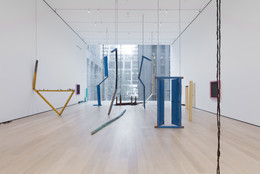 Sheela Gowda. Of All People. 2011. Wood doors, shutters, doorframes, windows, pillars, table and fragments, framed photographs, wood chips, and metal chains, overall dimensions variable. Committee on Painting and Sculpture Funds. © 2019 Sheela Gowda. Installation view, The Museum of Modern Art, New York, 2019. Digital Image © 2019 MoMA, NY. Photo: John Wronn