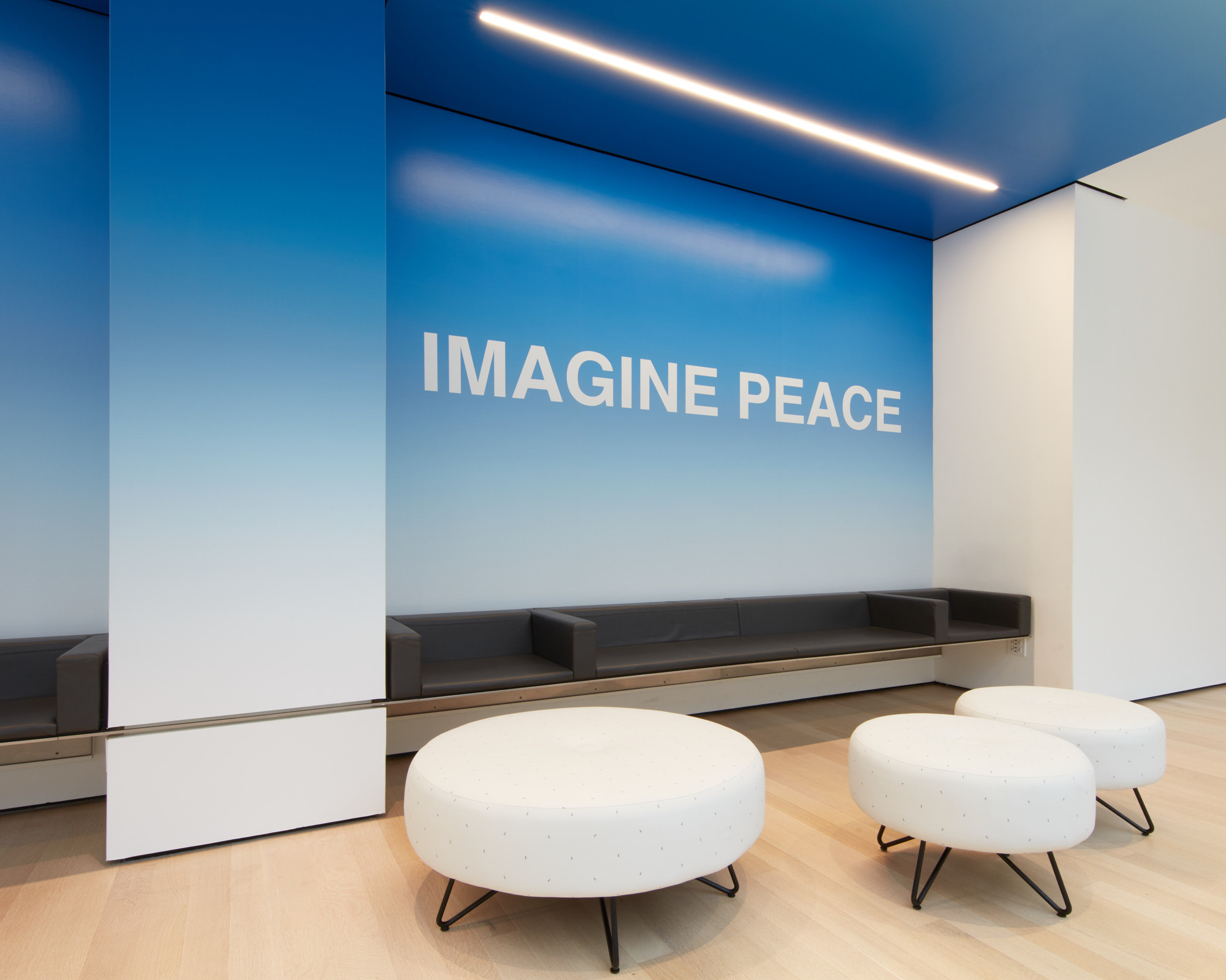 Yoko Ono's words Imagine Peace displayed on a blue wall at MoMA