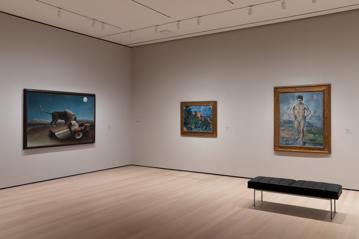 An installation view of Gallery 501. From left: Henri Rousseau’s The Sleeping Gypsy (1897) and Paul Cézanne’s Château Noir (1903–04) and The Bather (c. 1885)