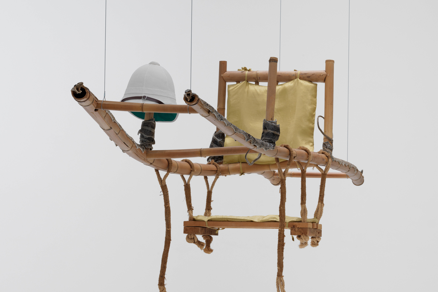 Huang Yong Ping. Palanquin. 1997 (artist proof made in 2002). Bamboo, cane, cushions, colonial hat, and snakeskin, 122 × 59 3/4 × 19 3/4" (309.9 × 151.8 × 50.2 cm). Gift of Marlene Hess and James D. Zirin and Jerry I. Speyer and Katherine Farley
