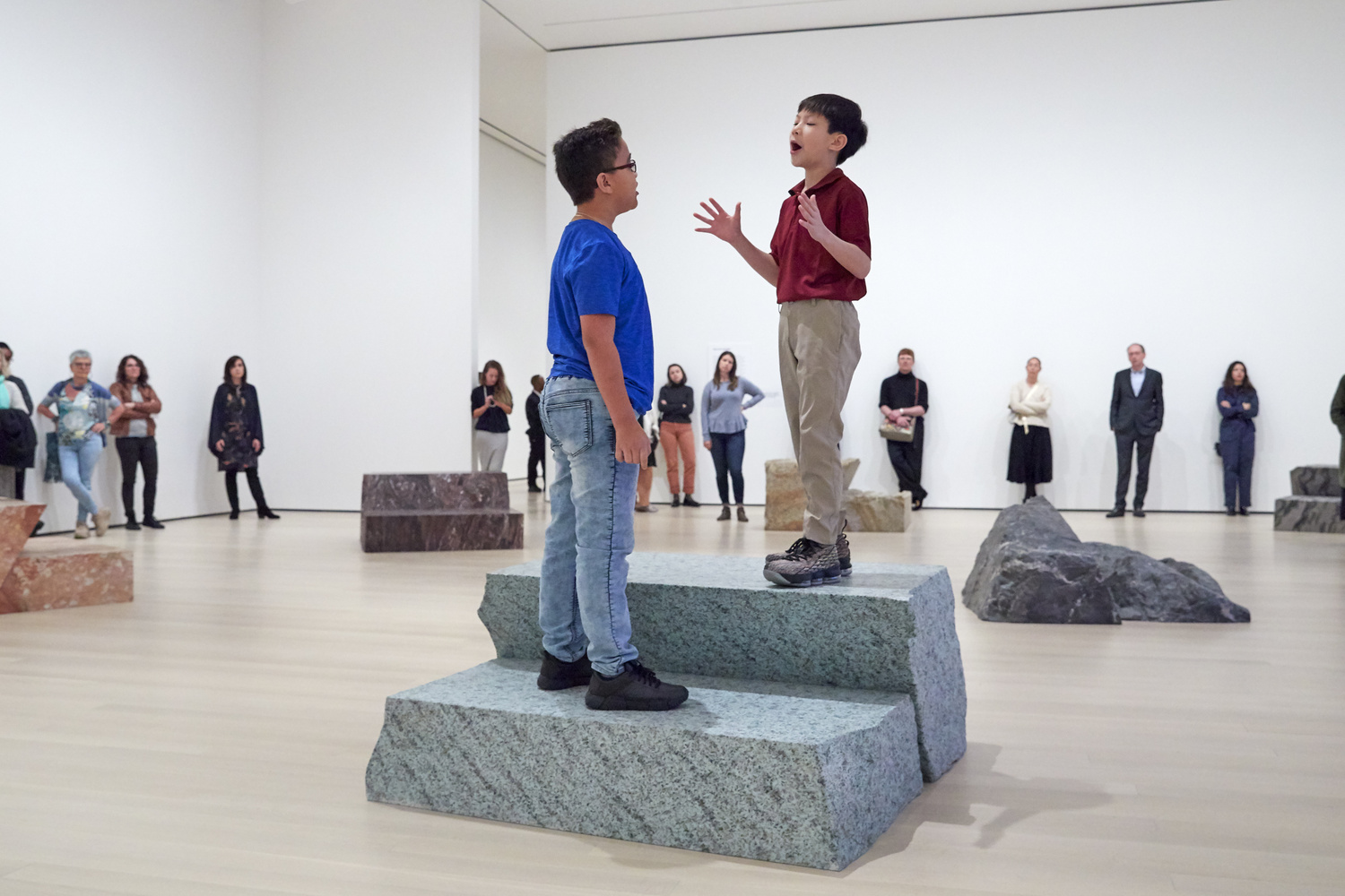 Jennifer Allora (American, born 1974). Guillermo Calzadilla (Cuban, born 1971). Fault Lines. 2013. Ten metamorphic and igneous rocks, live performance by two boy soprano singers. Music: Guarionex Morales-Matos (Puerto Rican, born 1968). Libretto: Allora & Calzadilla. The Museum of Modern Art, New York. Gift of Bob Rennie, 2016. © 2019 Jennifer Allora and Guillermo Calzadilla. Installation view, October 21, 2019-January 4, 2020, The Museum of Modern Art, New York. Image © 2019 The Museum of Modern Art. Photo: Heidi Bohnenkamp