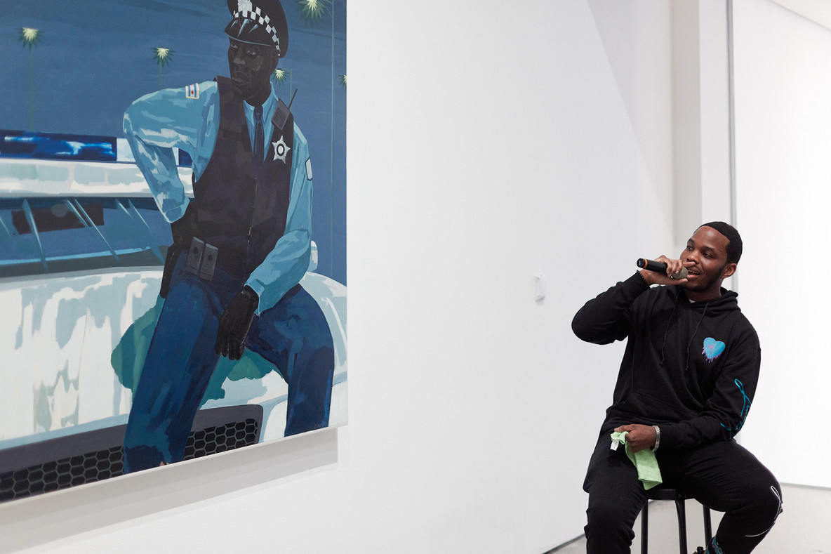 Kevin Reid speaks in front of Kerry James Marshall’s painting