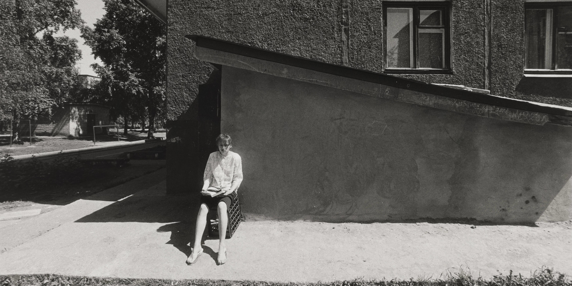 Alexander Slussarev. Untitled. (woman reading book, sitting on crate). 1994. Gelatin silver print, 9 13/16 × 14 11/16" (25 × 37.3 cm). E.T. Harmax Foundation Fund
