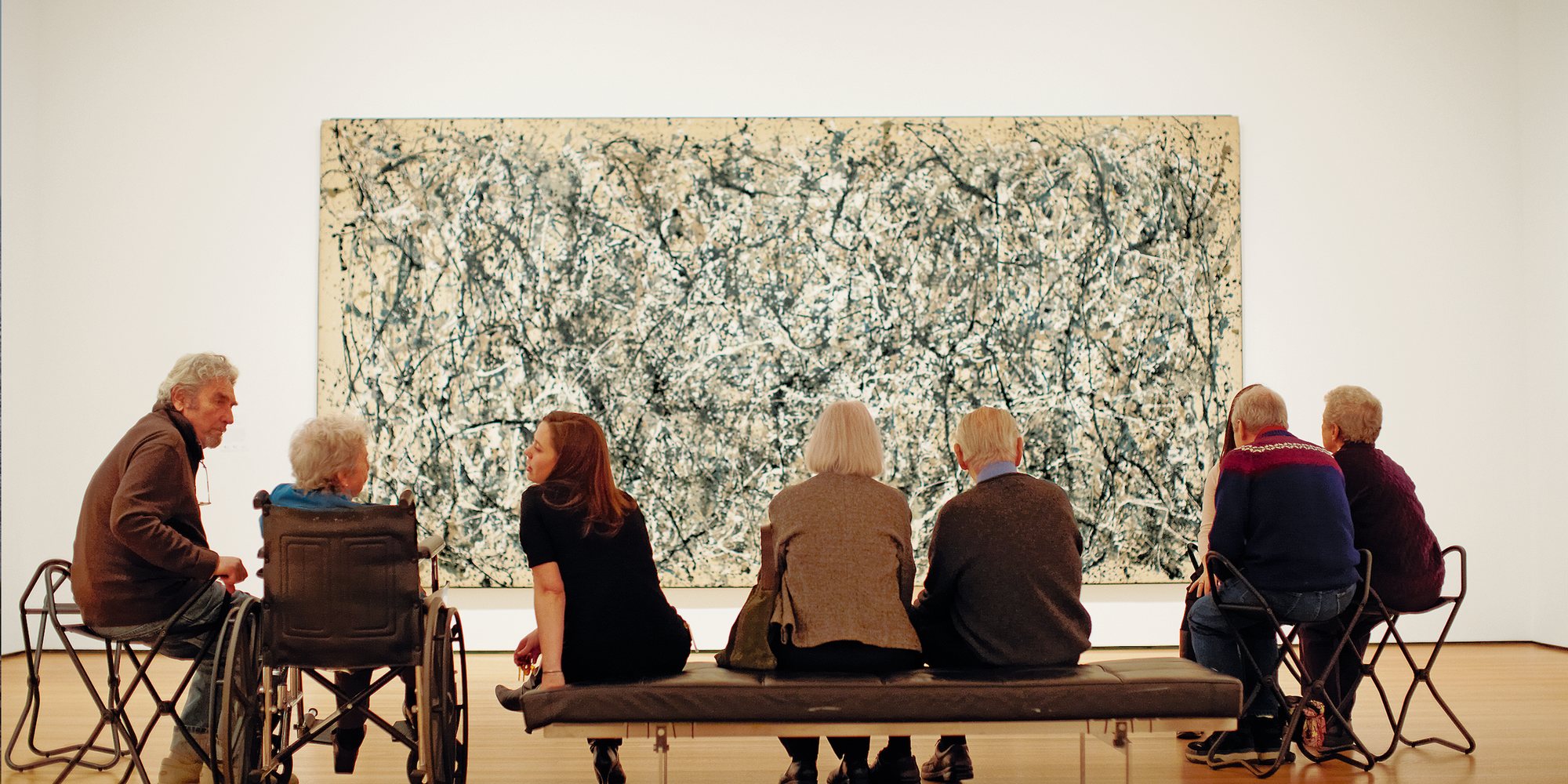 Visitors in the galleries. Shown: Jackson Pollock. One: Number 31, 1950. 1950. Oil and enamel paint on canvas, 8' 10" × 17' 5 5/8" (269.5 × 530.8 cm). Sidney and Harriet Janis Collection Fund (by exchange). Conservation was made possible by the Bank of America Art Conservation Project. © 2020 Pollock-Krasner Foundation/Artists Rights Society (ARS), New York. Photo: Jason Brownrigg