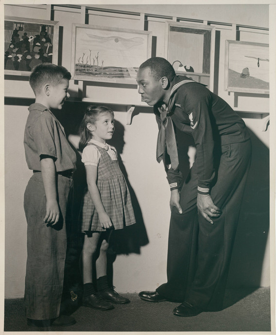 At MoMA through Time, take a look back at moments and milestones in the Museum’s past—like Jacob Lawrence greeting visitors to his 1944–45 exhibition Paintings by Jacob Lawrence.