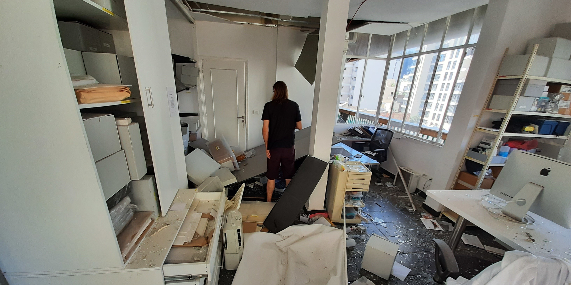 Surveying the damage to the Arab Image Foundation offices. Courtesy Arab Image Foundation, Beirut