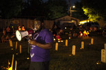 A young man reads out the names of police violence victims—those also present on the makeshift tombstones in the park—aloud to a crowd in Powderhorn, Minneapolis. Picture and caption by Laylah Amatullah Barrayn © 2020