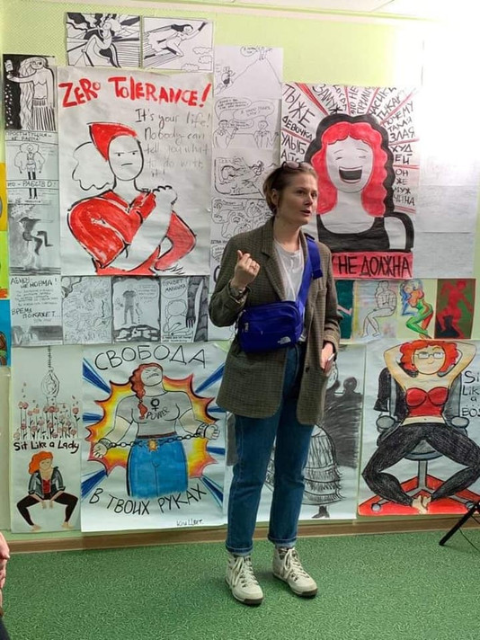 Tsvetkova speaking in front of her drawings