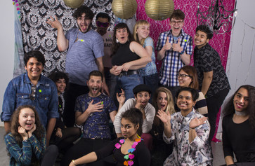 Open Art Space teens and teaching artists pose before a backdrop smiling at the camera. Photo: Néstor Pérez-Molière