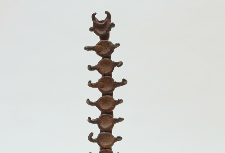 Isamu Noguchi. Small Centipede. c. 1952. Unglazed Karatsu red stoneware and wood, 15 3/4 x 4 3/4 x 4 3/4" (40 x 12.1 x 12.1 cm) including wood base. Gift of Mr. and Mrs. George Heard Hamilton in honor of Richard E. Oldenburg. © 2017 Estate of Isamu Noguchi / Artists Rights Society (ARS), New York. Photo: Paige Knight