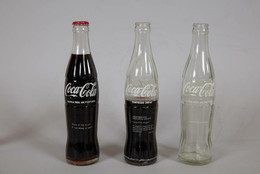 Cildo Meireles. INSERTIONS INTO IDEOLOGICAL CIRCUITS: 1. COCA-COLA PROJECT (INSERÇÕES EM CIRCUITOS IDEOLÓGICOS: 1. PROJETO COCA-COLA). 1970. Printed pressure-sensitive labels on three commercial glass bottles, dimensions variable. Gift of Lilian Tone.