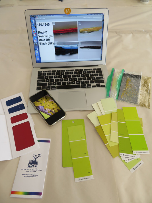Comparing paint coupons to cross-sections of samples from the sculpture. Photo: Abigail Mack