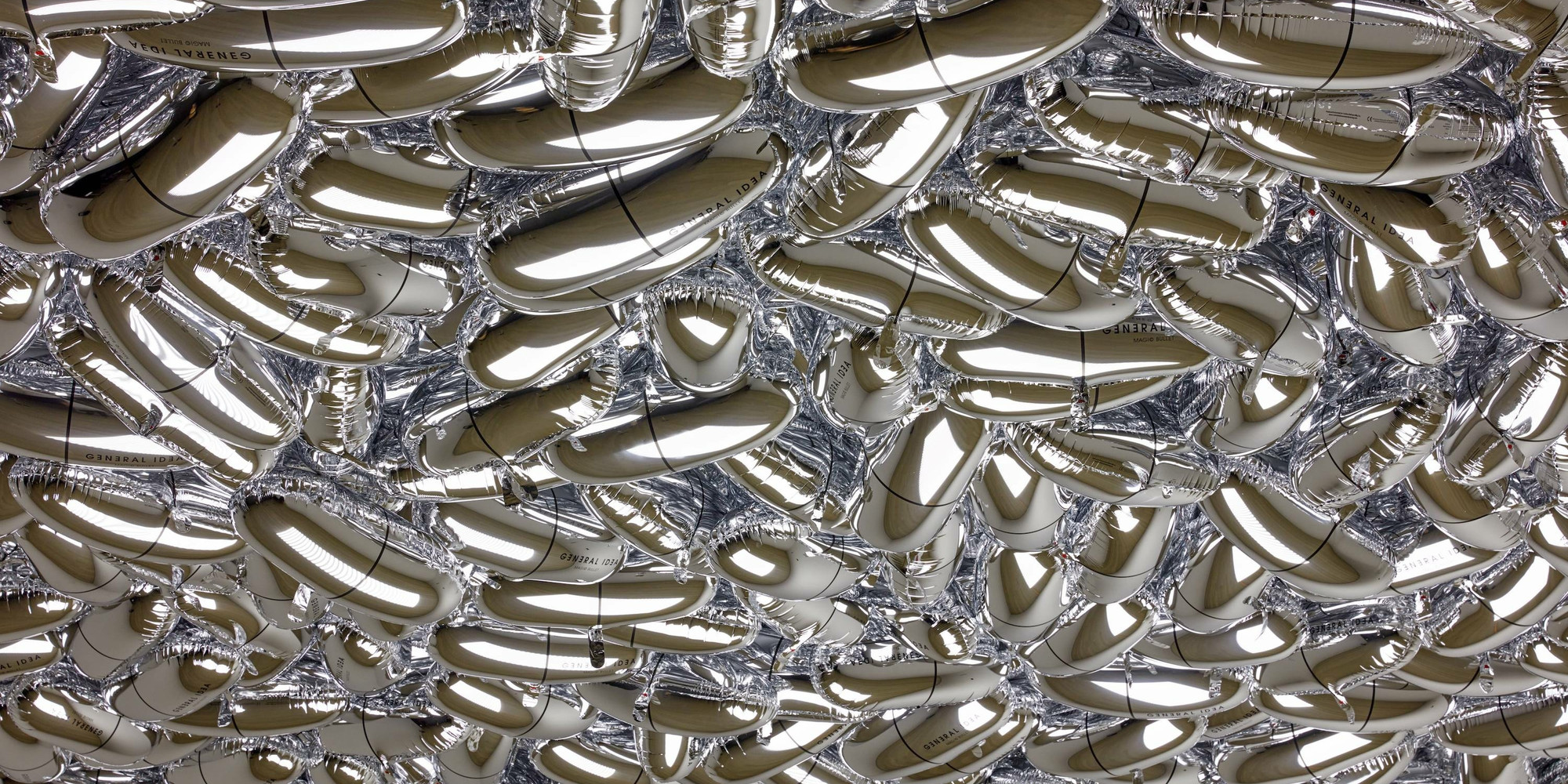 General Idea. Magi© Bullet. 1992. Installation of custom-shaped Mylar balloons, dimensions variable. Edition: 3. The Museum of Modern Art, New York. Gift of Mark Krayenhoff. © 2021 General Idea. Installation view, General Idea’s Magi© Bullet, The Museum of Modern Art, New York, November 14, 2020–summer 2021. Digital Image © 2021 The Museum of Modern Art, New York. Photo: Robert Gerhardt